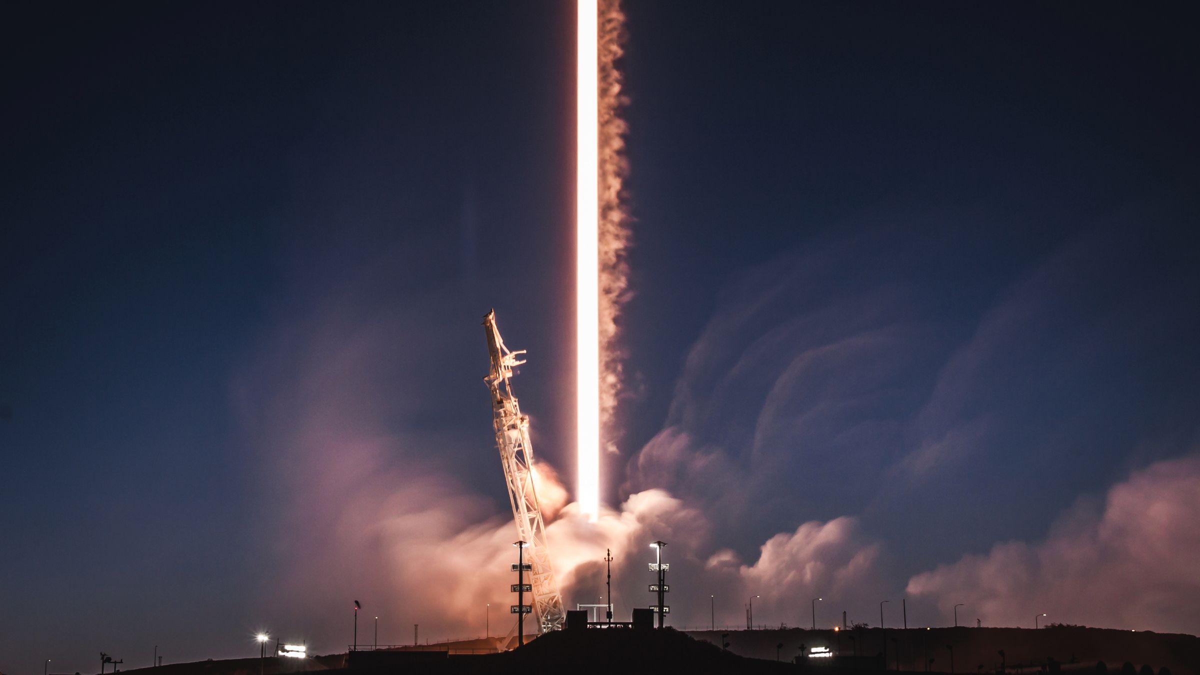 Falcon 9 leaves a trail of light as it lifts off from Vandenberg Air Force Base